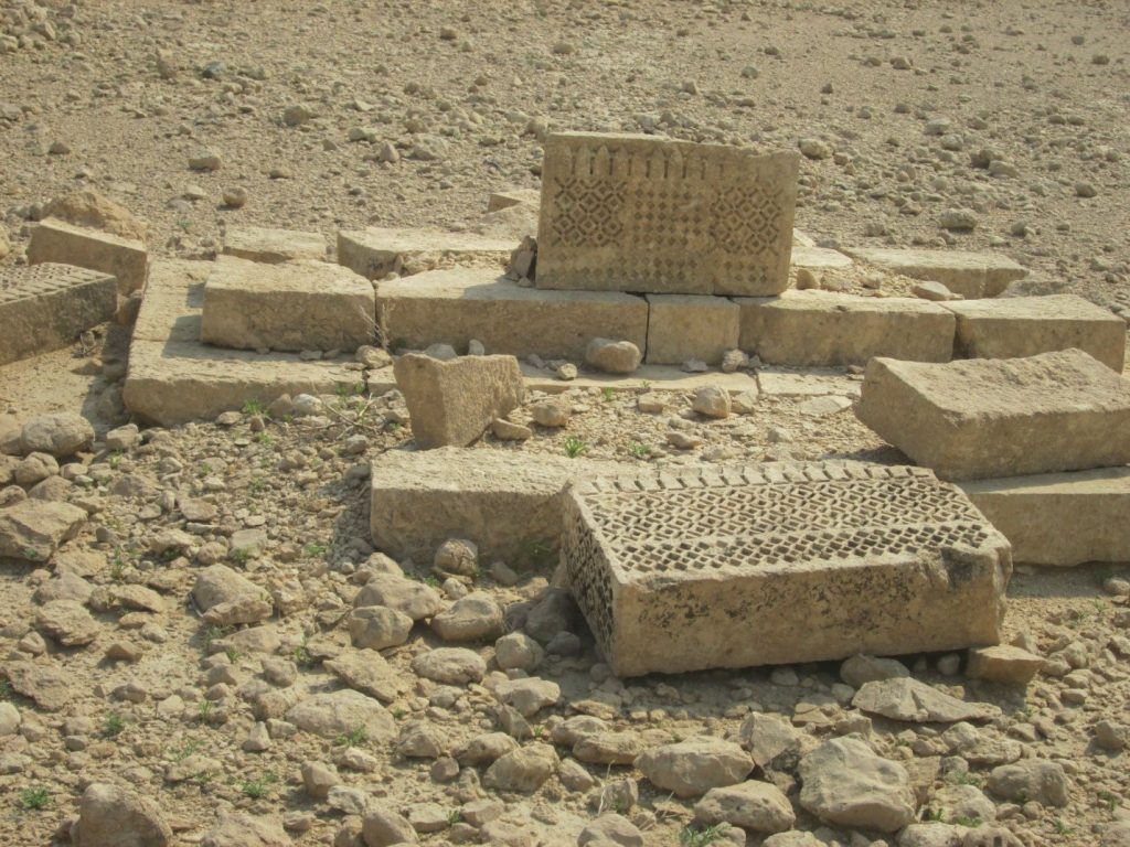 Carved slab of grave with square motifs