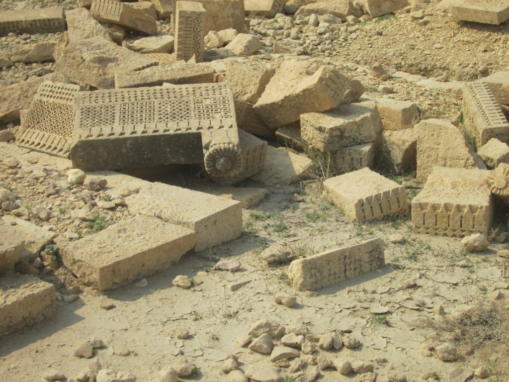 07 Carved stone slabs scattered on surface with rosette and square Motifs – Sindh Courier