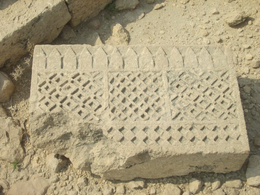 Carved stone slab with geometric motifs